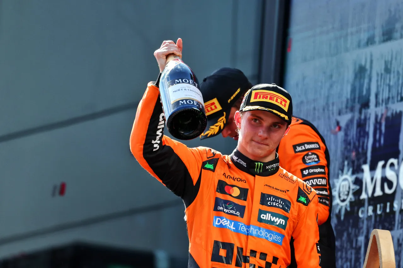 Oscar Piastri celebrating his P2 result on the podium at the Austrian Grand Prix