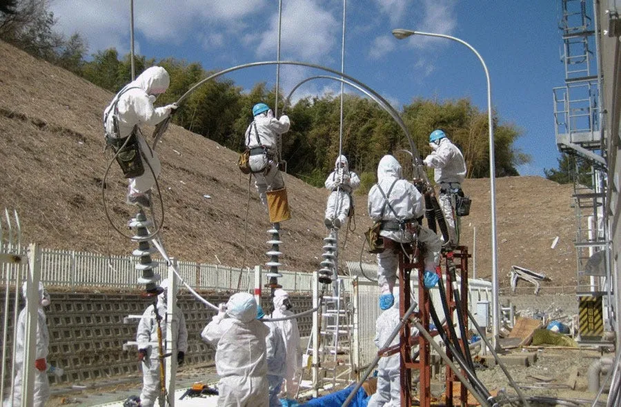 here workers in protective gear try to restore electricity