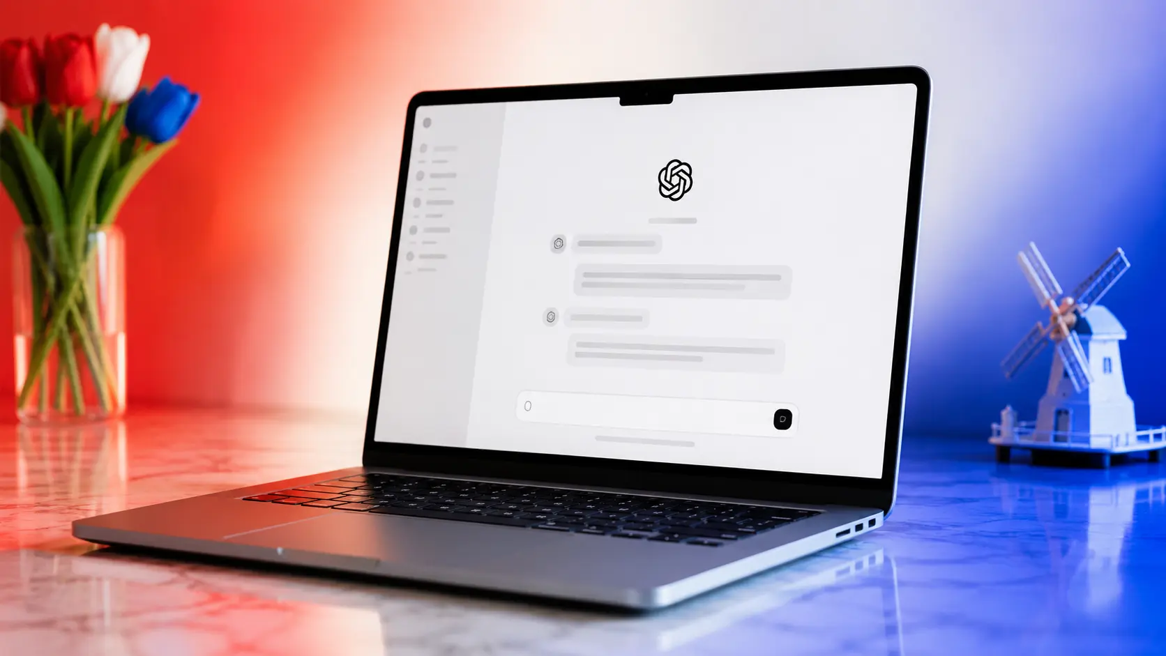 ChatGPT open on a silver MacBook surrounded by red, white and blue lighting inspired by the Dutch flag.