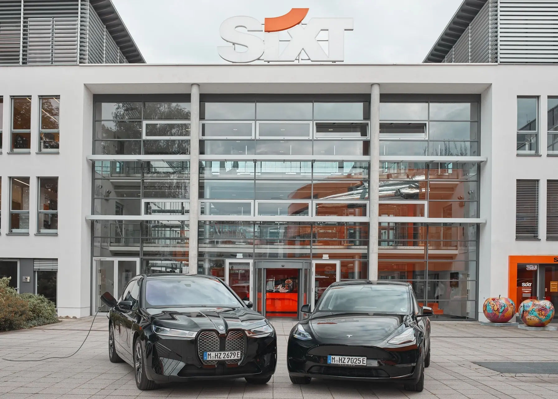sixt bmwixandteslamodelyinfrontofsixtheadquartersinpullach landscape