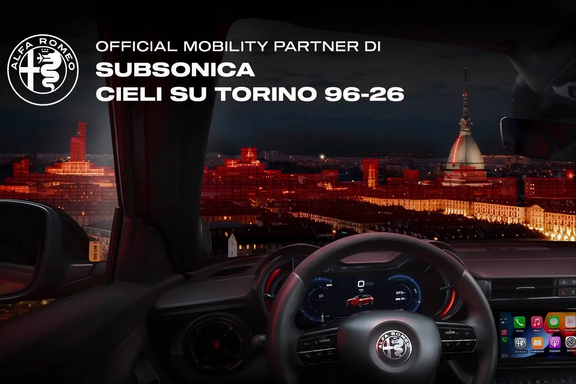 immagine dell'interno di una alfa romeo junior con sfondo di torino di notte mole antonelliana e centro città illuminato. in alto a sinistra la scritta che parla della partneship tra alfa romeo e il gruppo musicale subsonica