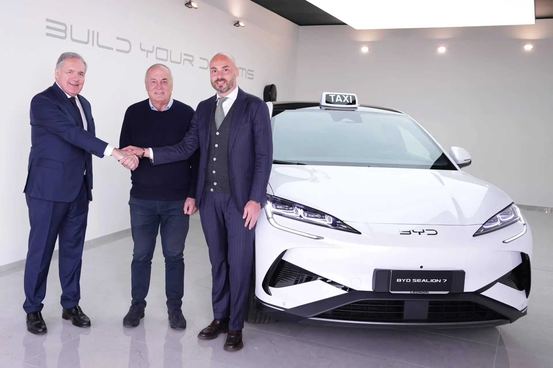 alfredo altavilla e alessandro grosso con il presidente di itTaxi e sullo sfondo una sealion 7 bianca taxi