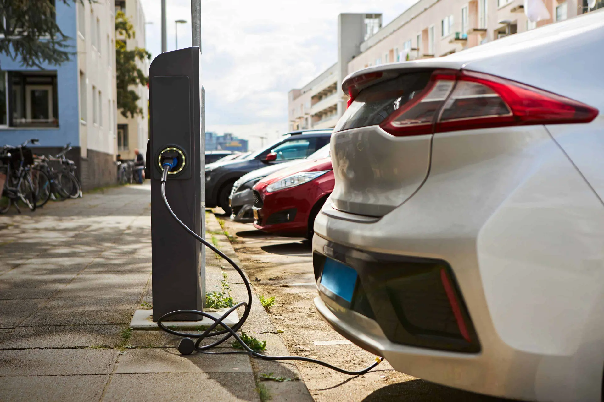 ey silver electric car at charging station