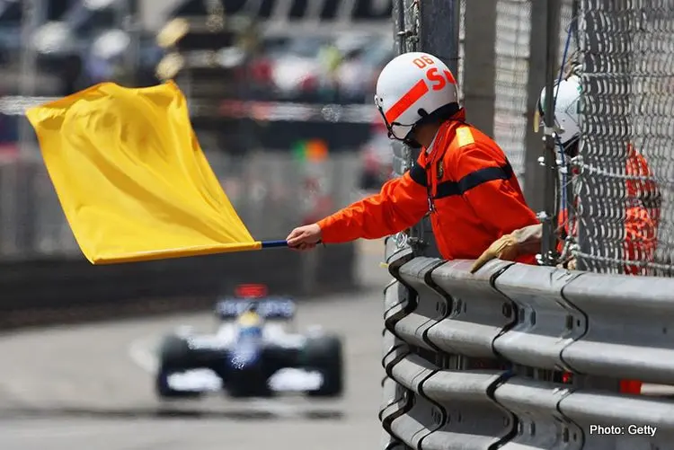 yellow flag is waved by marshalls