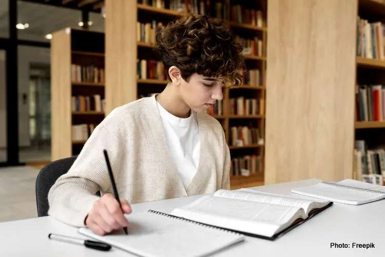 young student learning library study