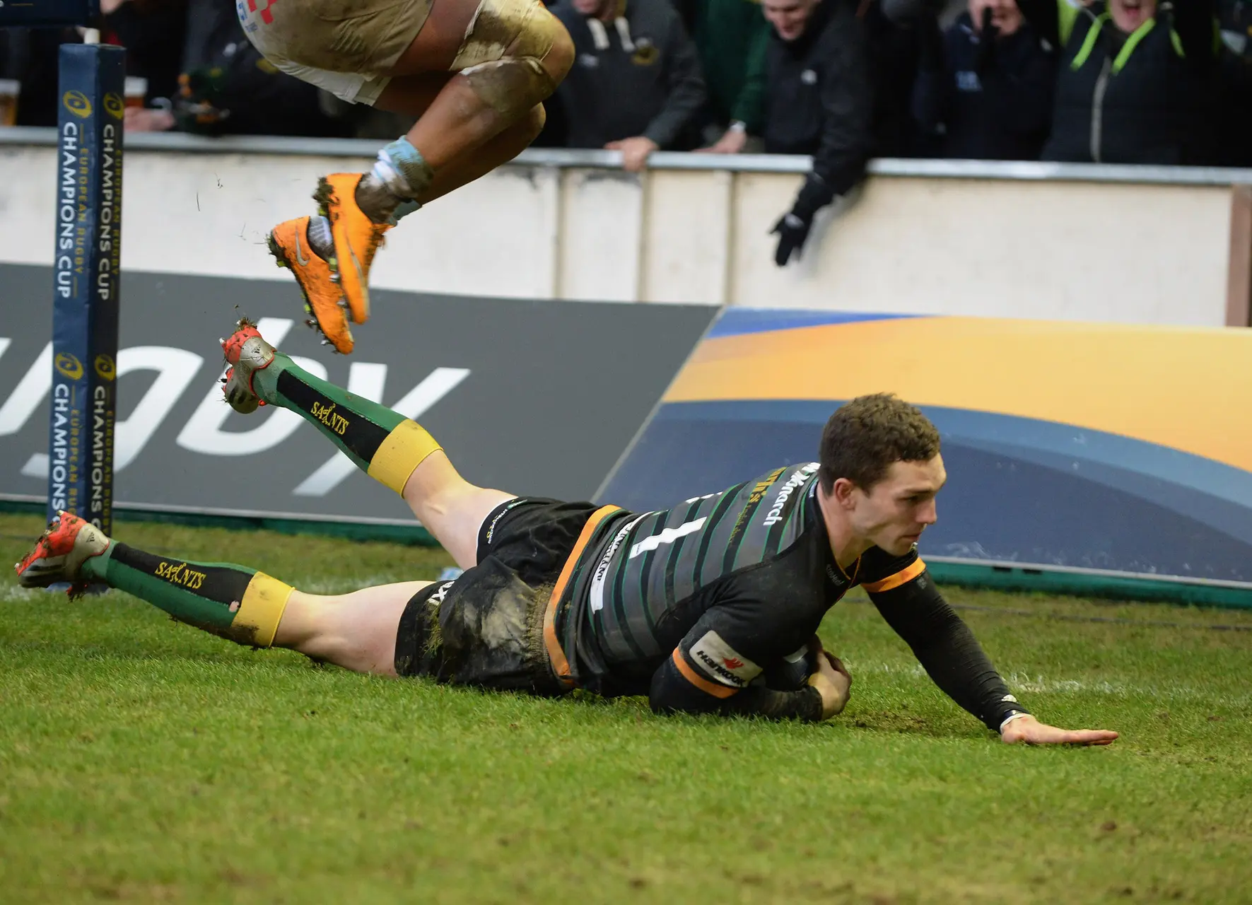NORTHAMPTON, ENGLAND - JANUARY 24: George North of Northampton Saints dives in to score a try during the European Rugby Champions Cup match between Northampton Saints and Racing Metro 92 at Franklin's Gardens on January 24, 2015 in Northampton, England. (