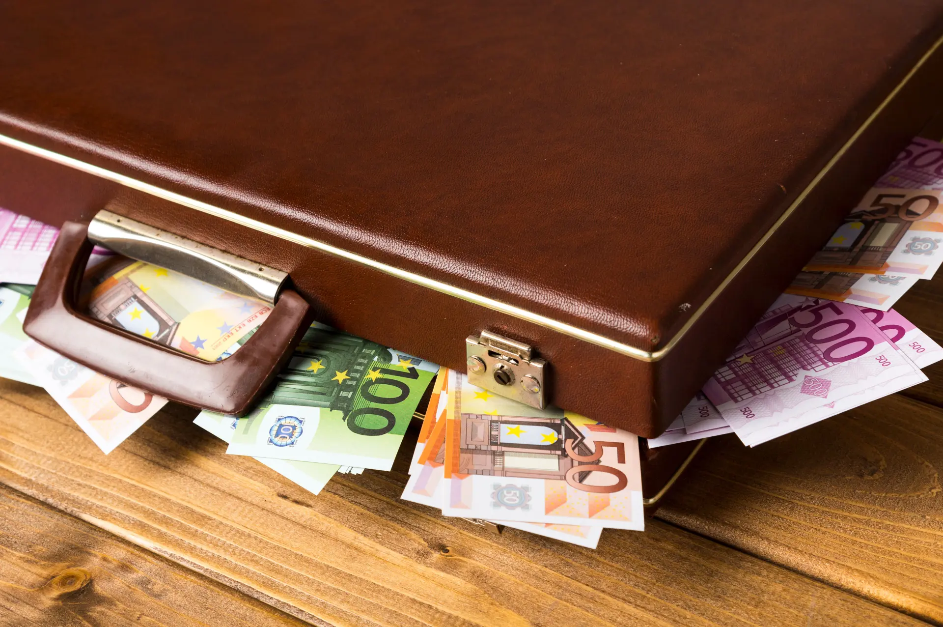 close up closed suitcase with banknotes inside