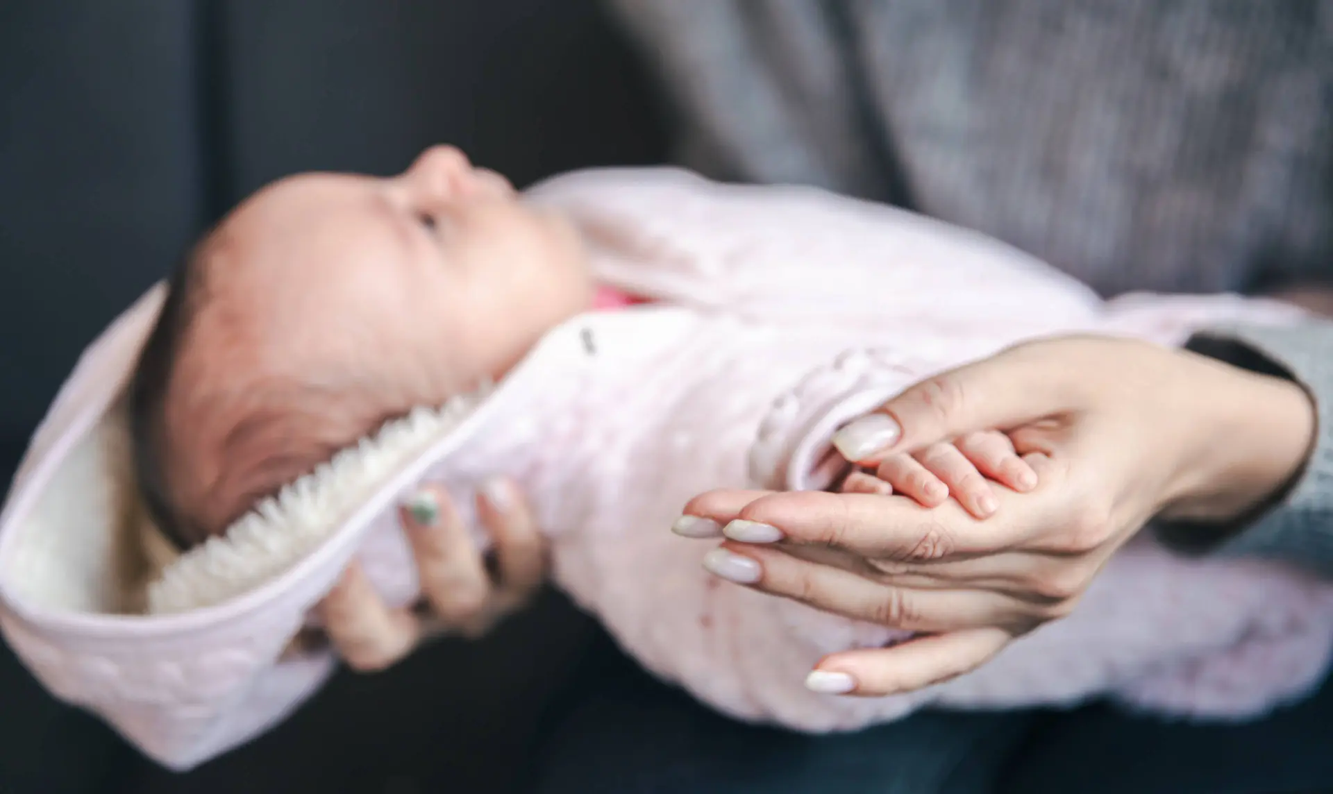 closeup-pen-newborn-baby-girl-moms-hand