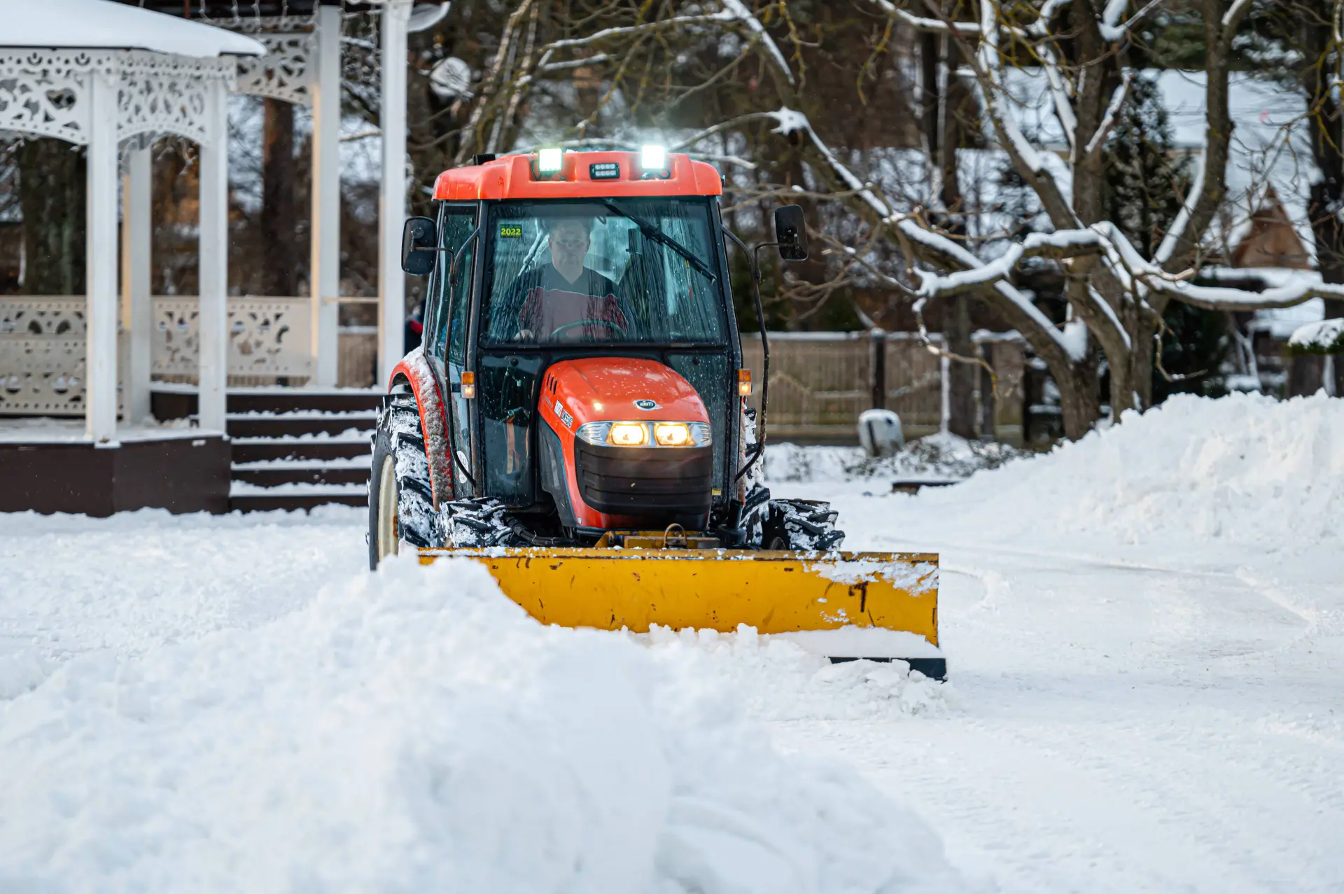 snow-removal-tractor-cleans-area-park-municipal-service-cleaning-sidewalk-from-snow
