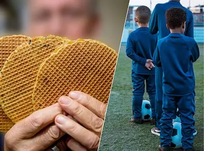 stroopwafels an organised team of young black boy children at a soccer training football pitch on a beautiful sunny day in the netherlands