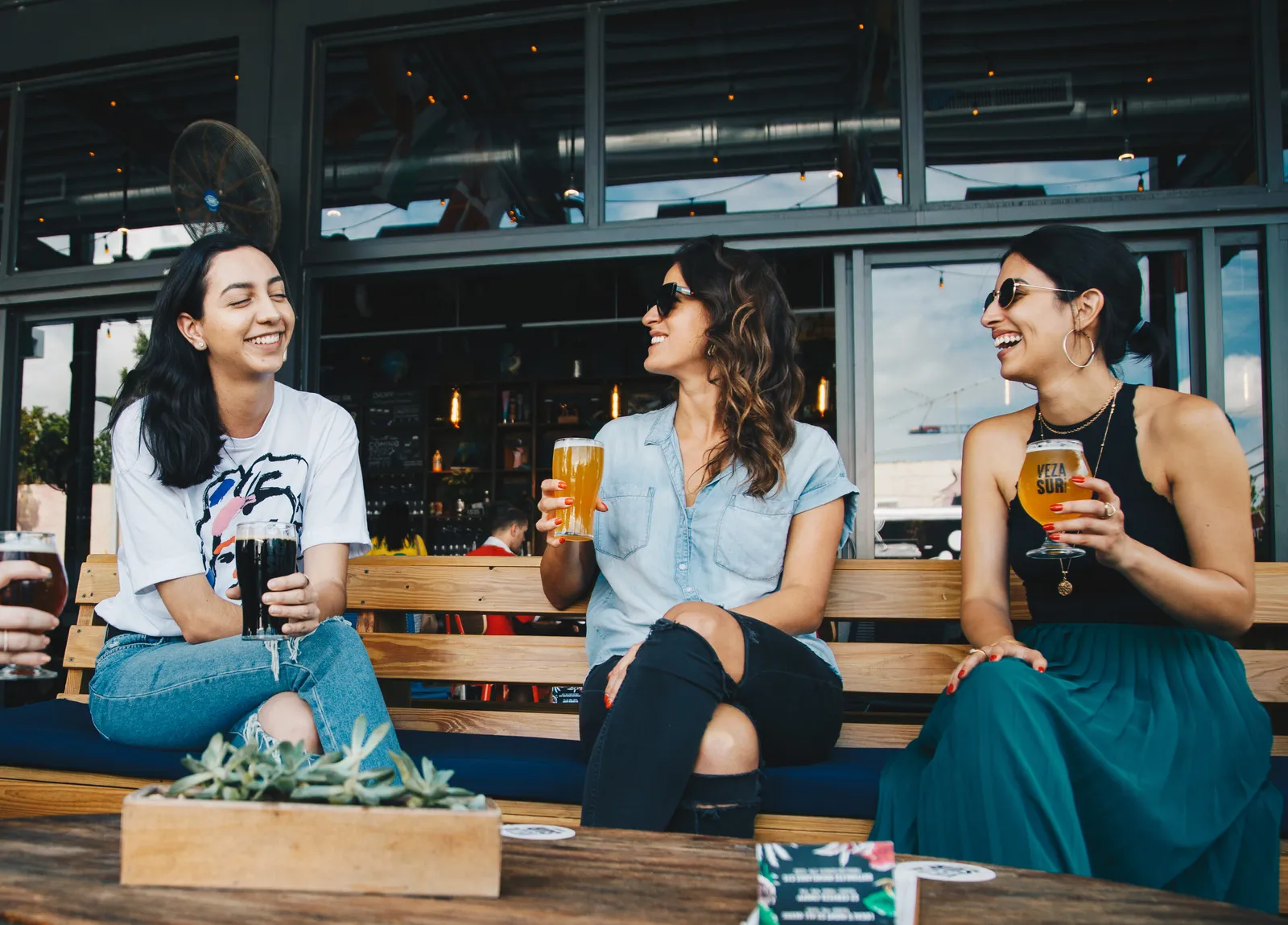 canva three women sitting on bench 1