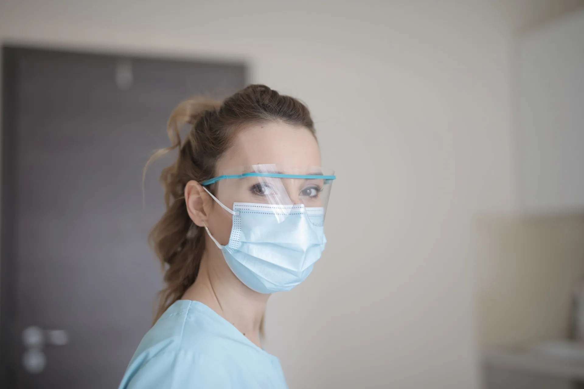 woman in blue shirt wearing face mask 3881247