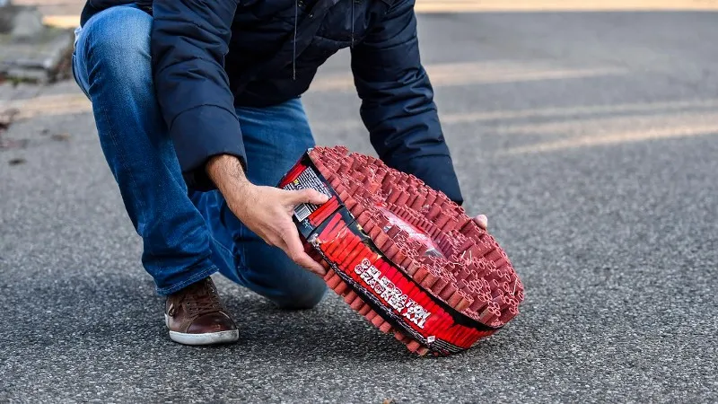 politieman rolt vuurwerkrol uit op straat