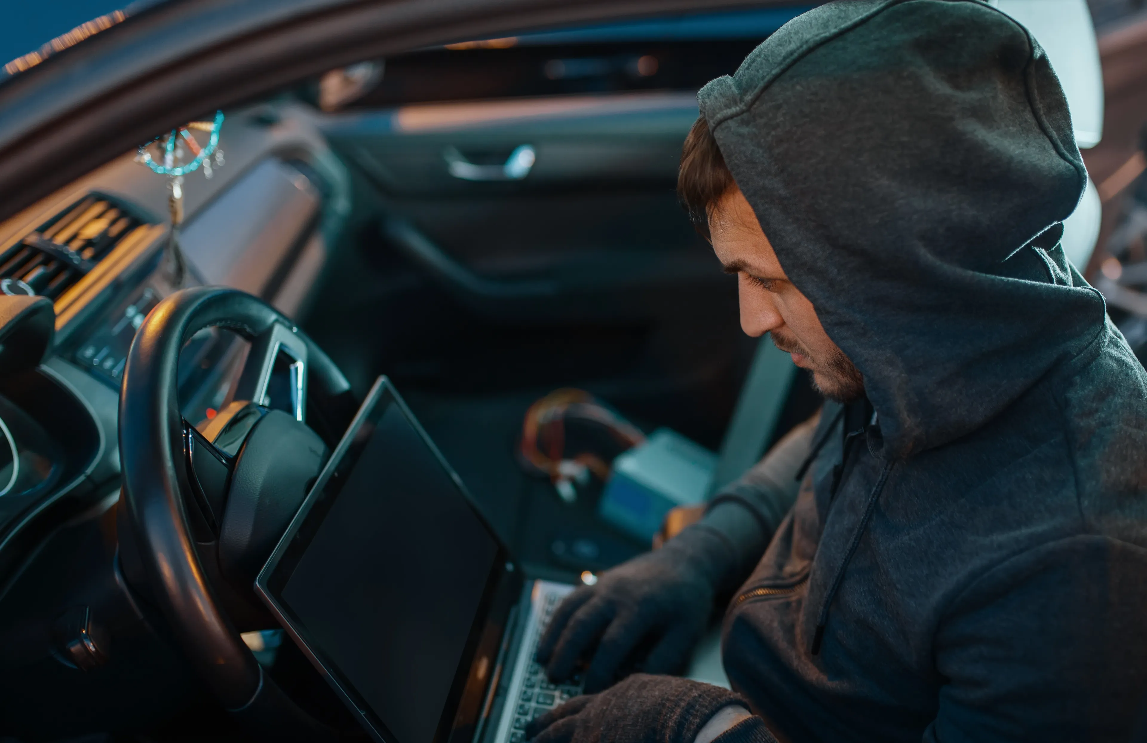 car thief with laptop hacking security system ymppjjg