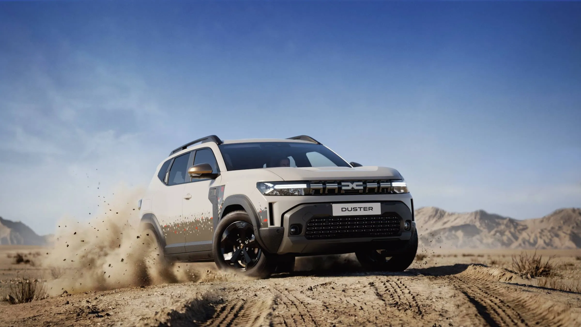 Dacia Duster Spirit of Sand nel deserto che percorre una strada sterrata di frontale