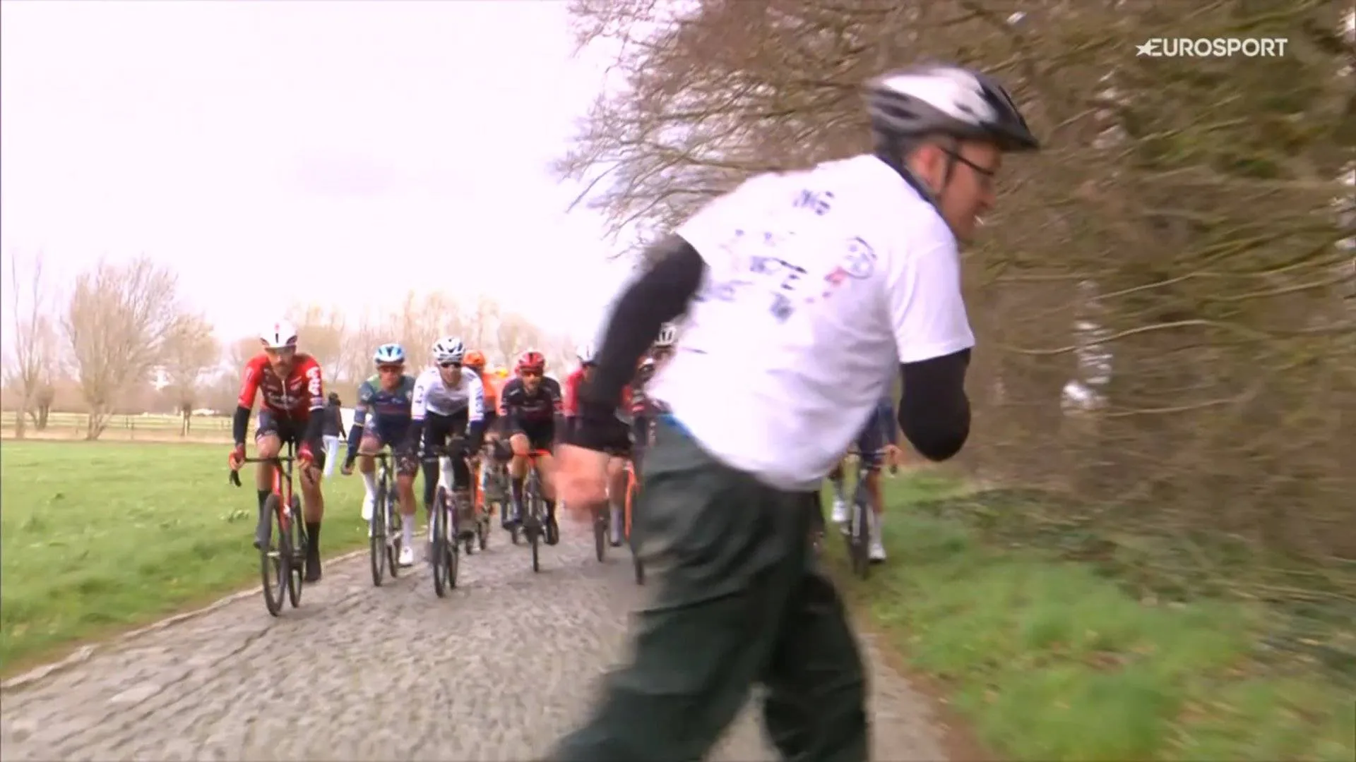 A protestor crosses the road at the 2026 Tour of Bruges, causing Juan Sebastián Molano to crash