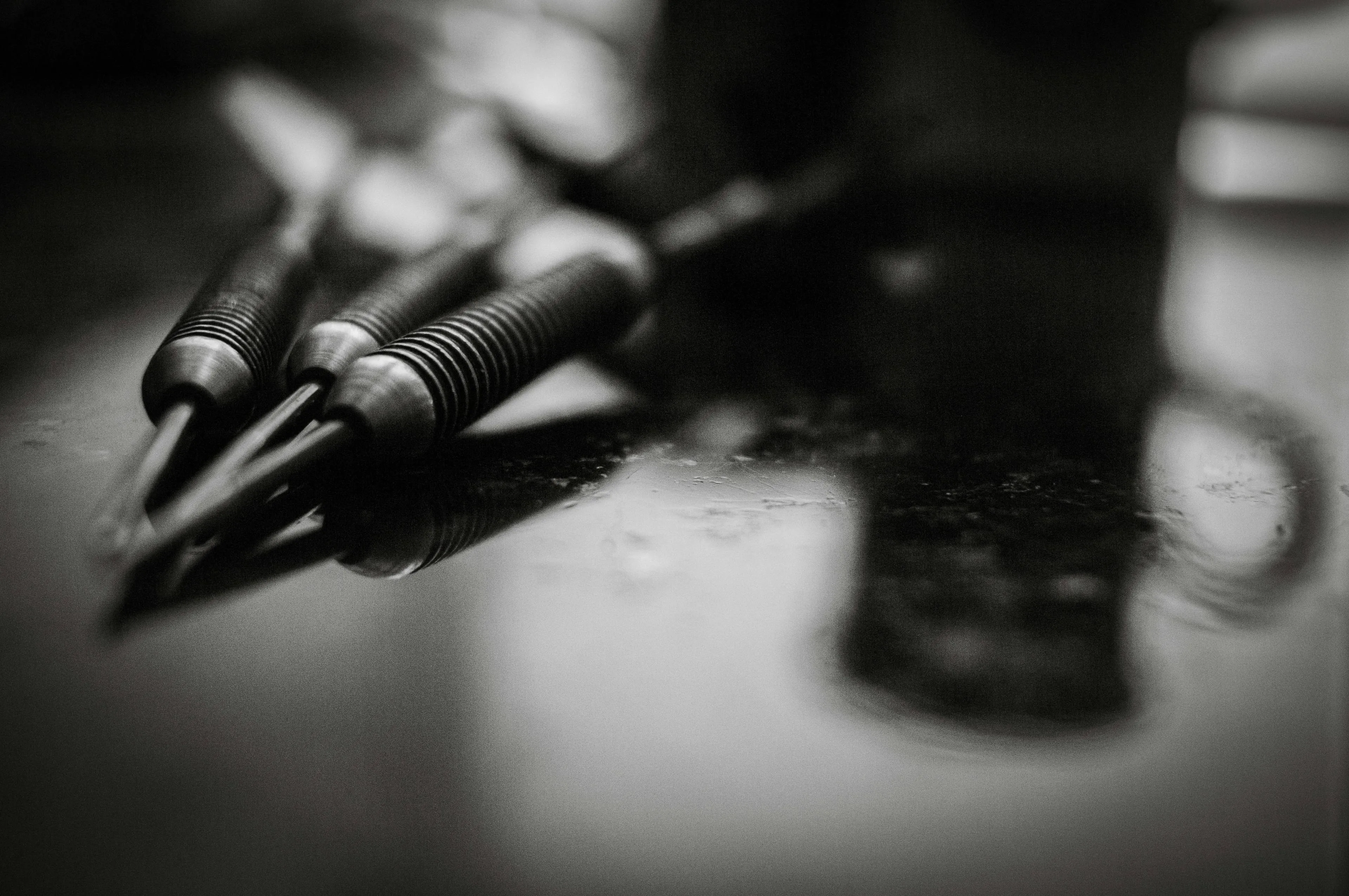 a-black-and-white-photo-of-pens-and-a-cell-phone-