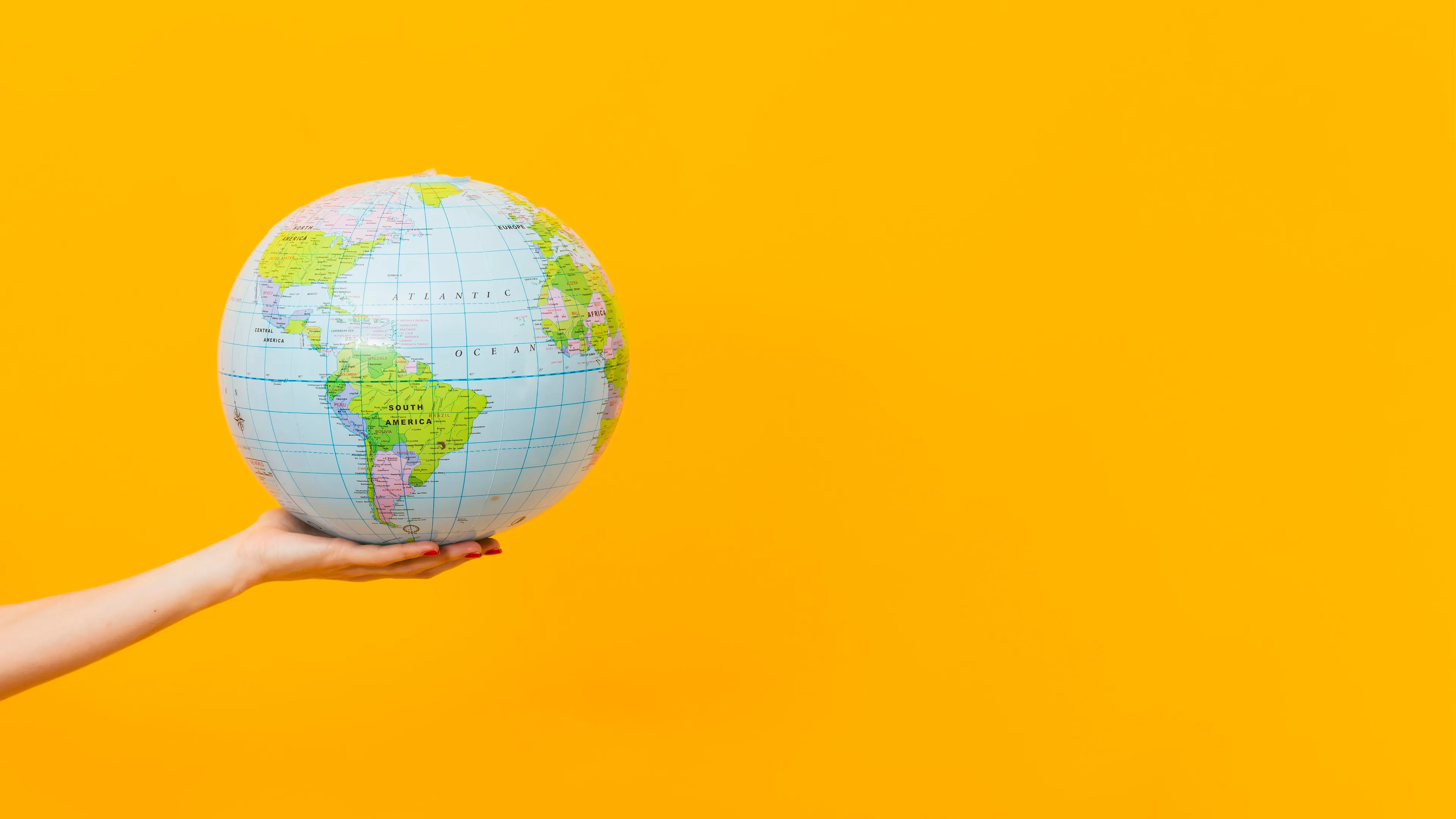 side view hand holding earth globe with copy space