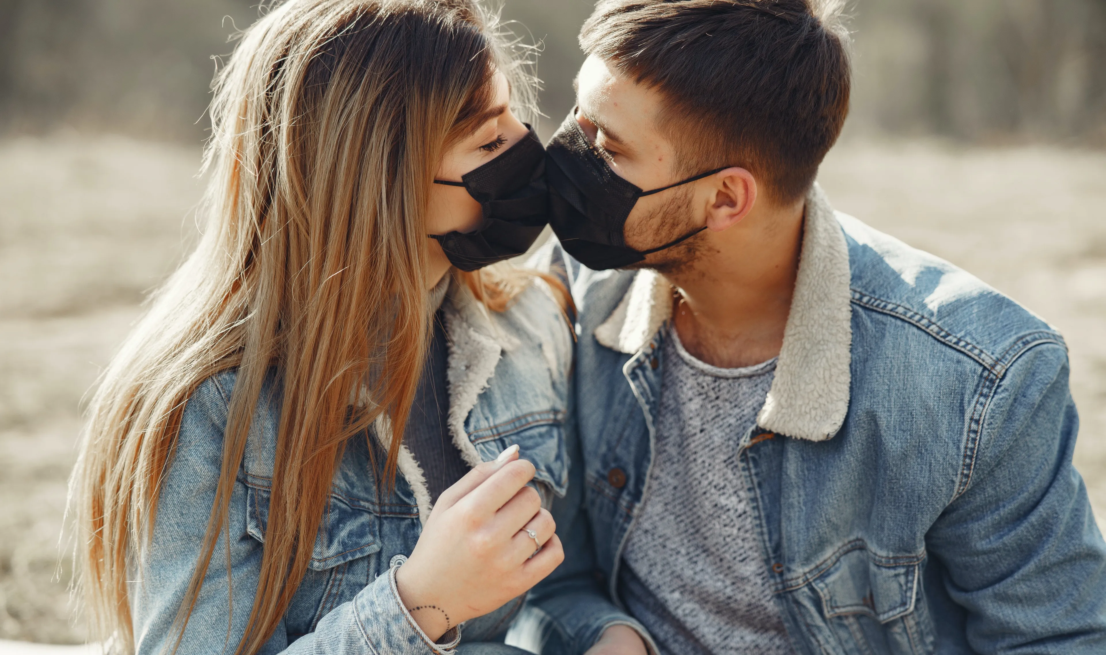 loving young couple kissing while wearing black medical 4005101 e1593083348821