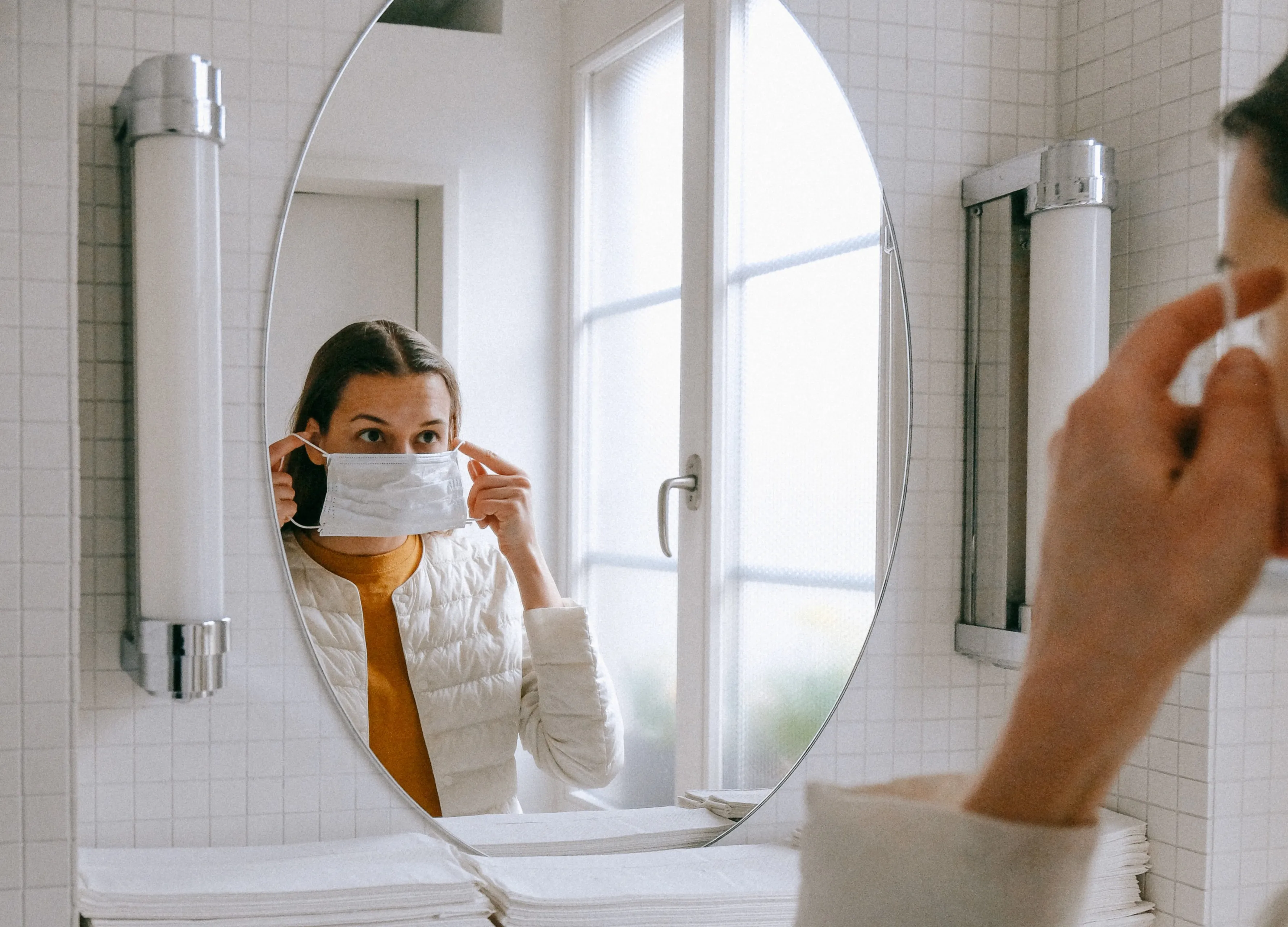 person putting on face mask 3943904 e1585648121937