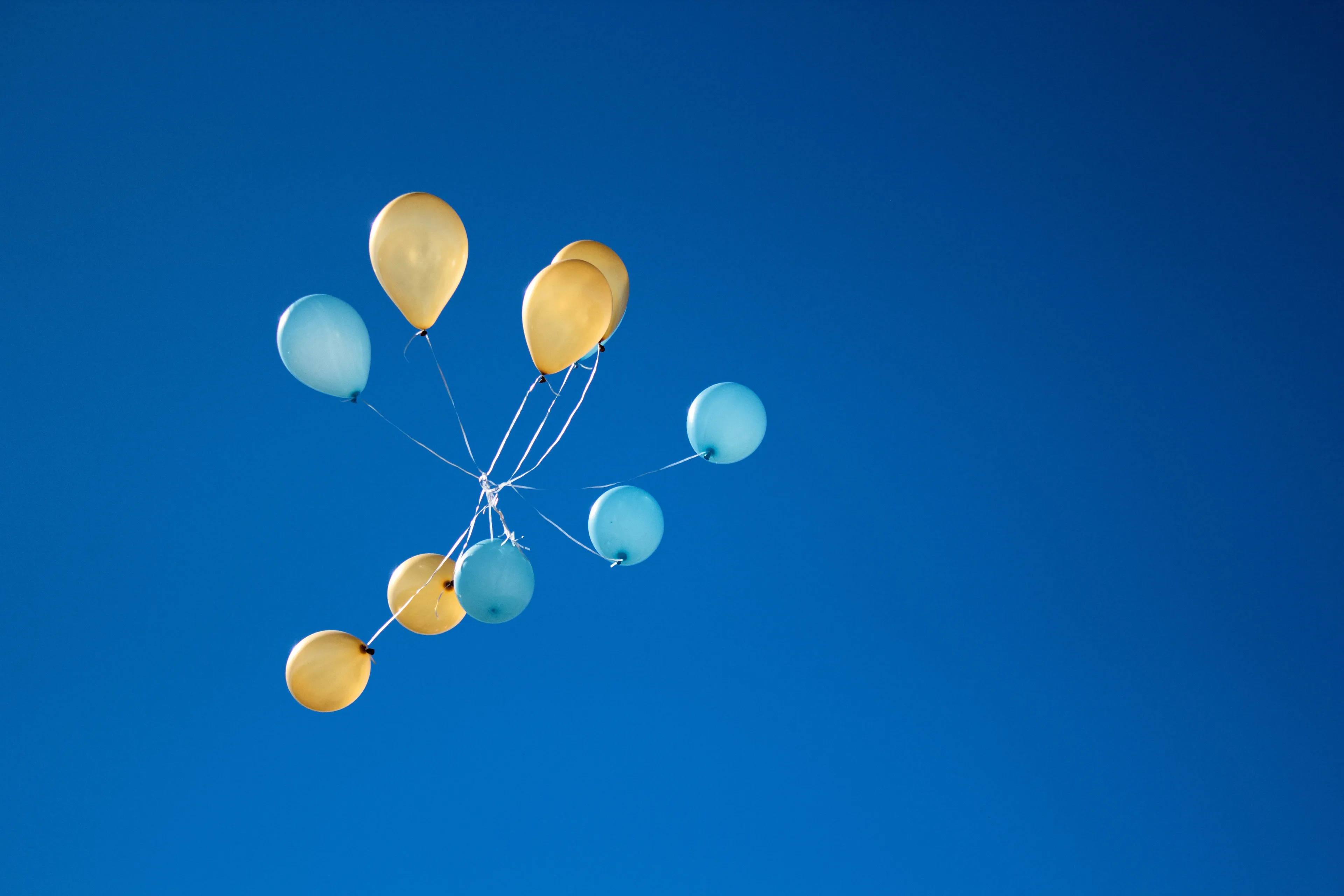 photo of yellow and blue balloons on sky 1590915