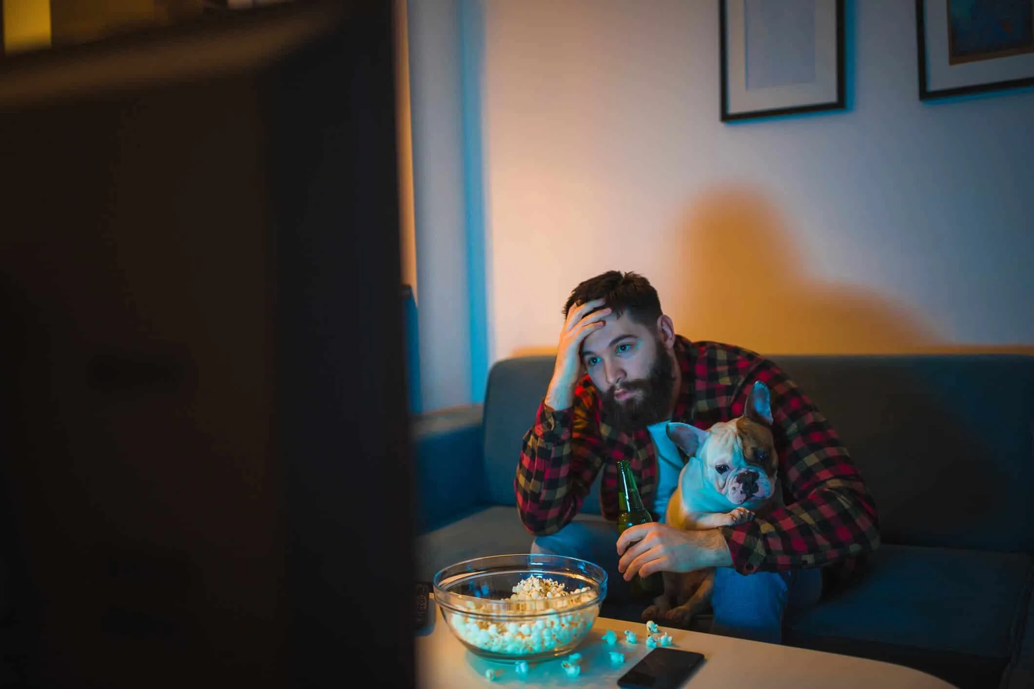 man trying to watch disney plus with his dog