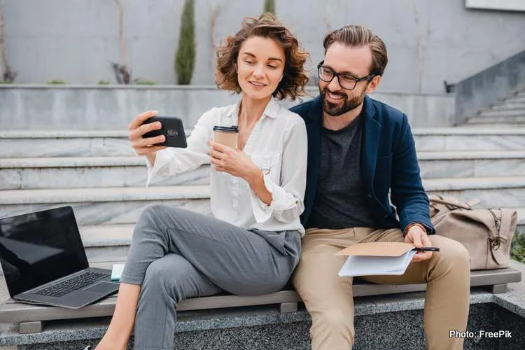 attractive couple man woman sitting stairs urban city center