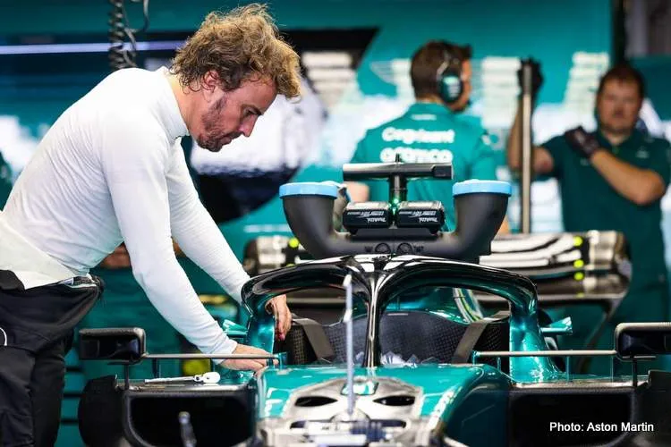 fernando alonso leaning over aston martin
