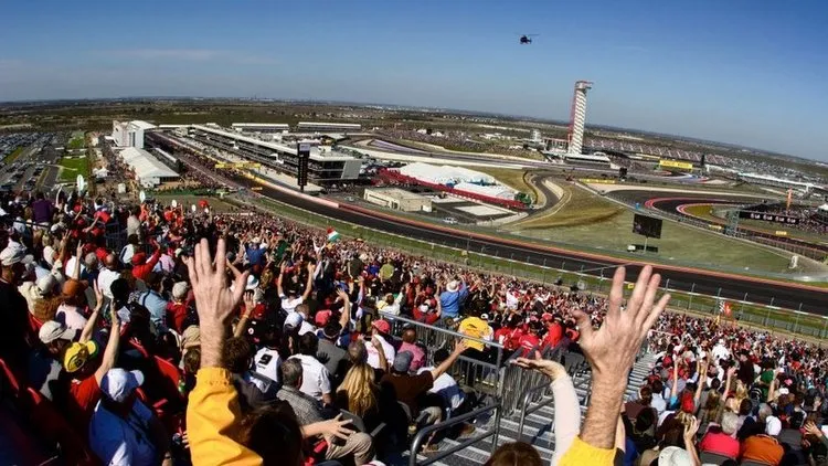 formula one us grand prix track austin texas trackside east turn 1 view of track and main stretch fans cheering helicopter circuit of the americas experiences