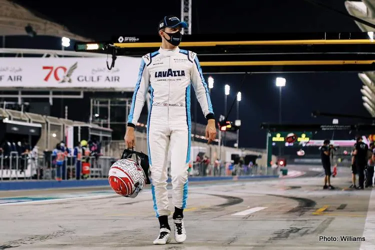 george russell walks with helmet