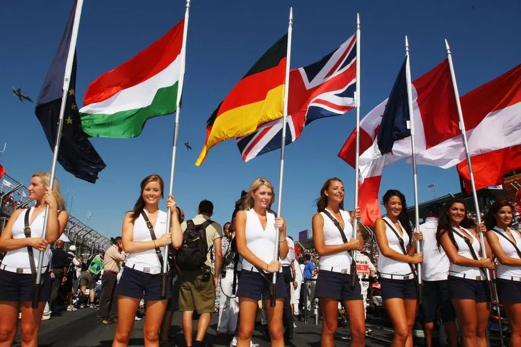 hi res 80265825 grid girls hold the national flags of all of drivers crop exact