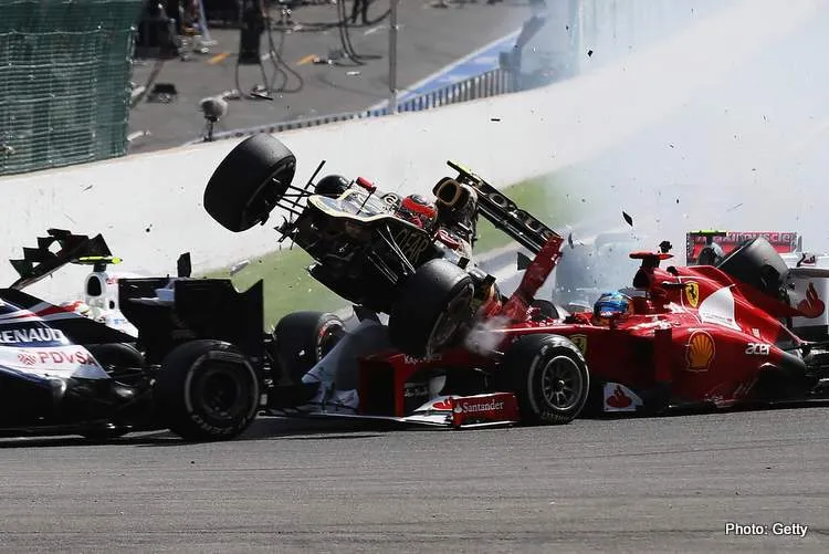 romain grosjean and fernando alonso crash at the start of the 2012 belgian f1 grand prix