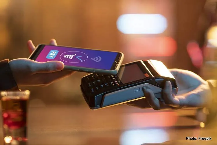 side view adult paying with card