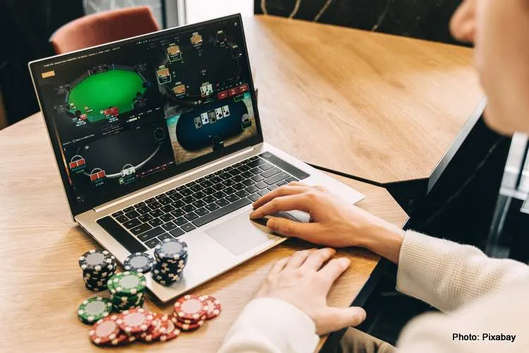 young man play online poker in laptop 2023 11 27 04 49 41 utc 2