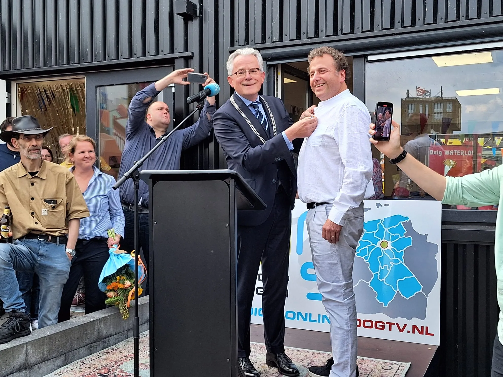 burgemeester koen schuiling speldt evert janse de versierselen op foto rick van der velde