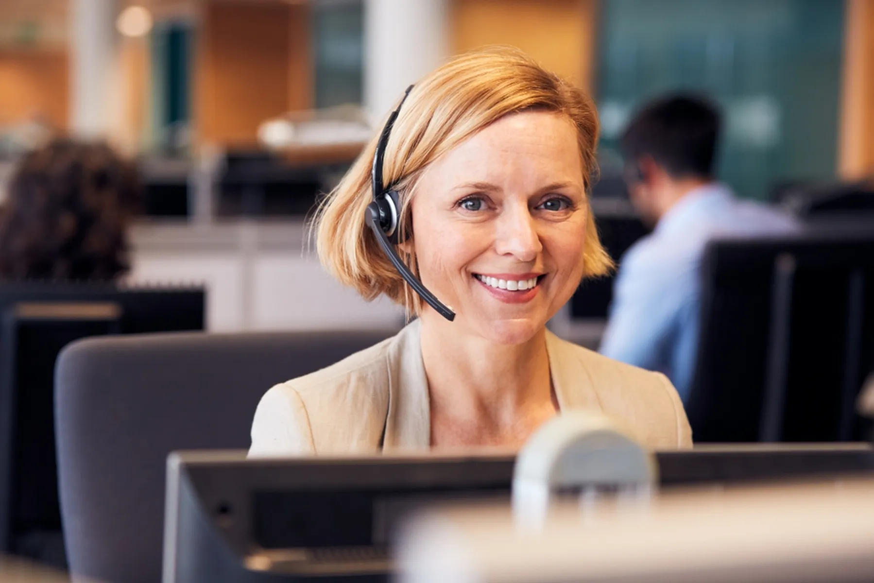 Portrait,Of,Mature,Businesswoman,Wearing,Telephone,Headset,Working,In,Customer