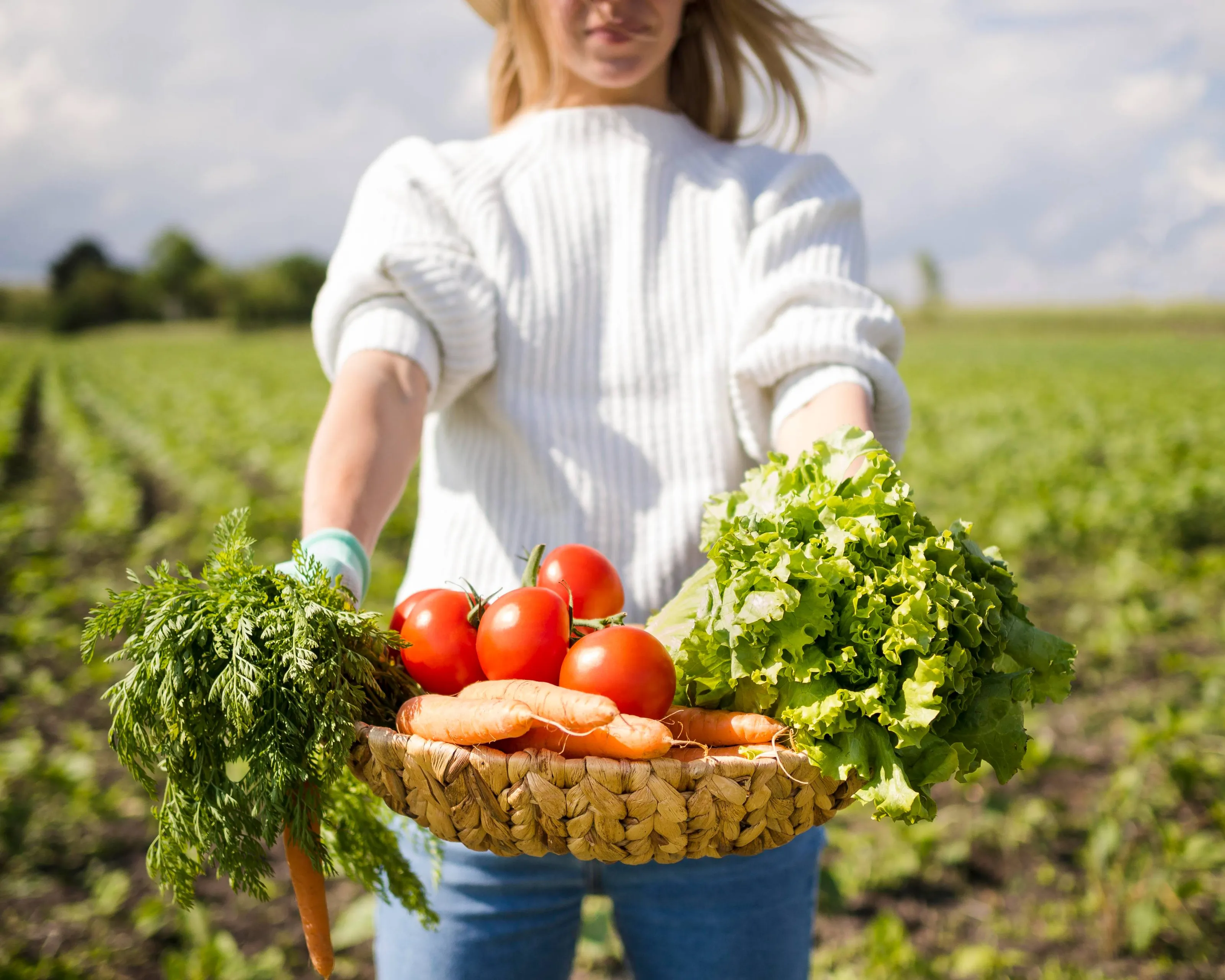 woman-holding-basket-full-vegetables-front-her