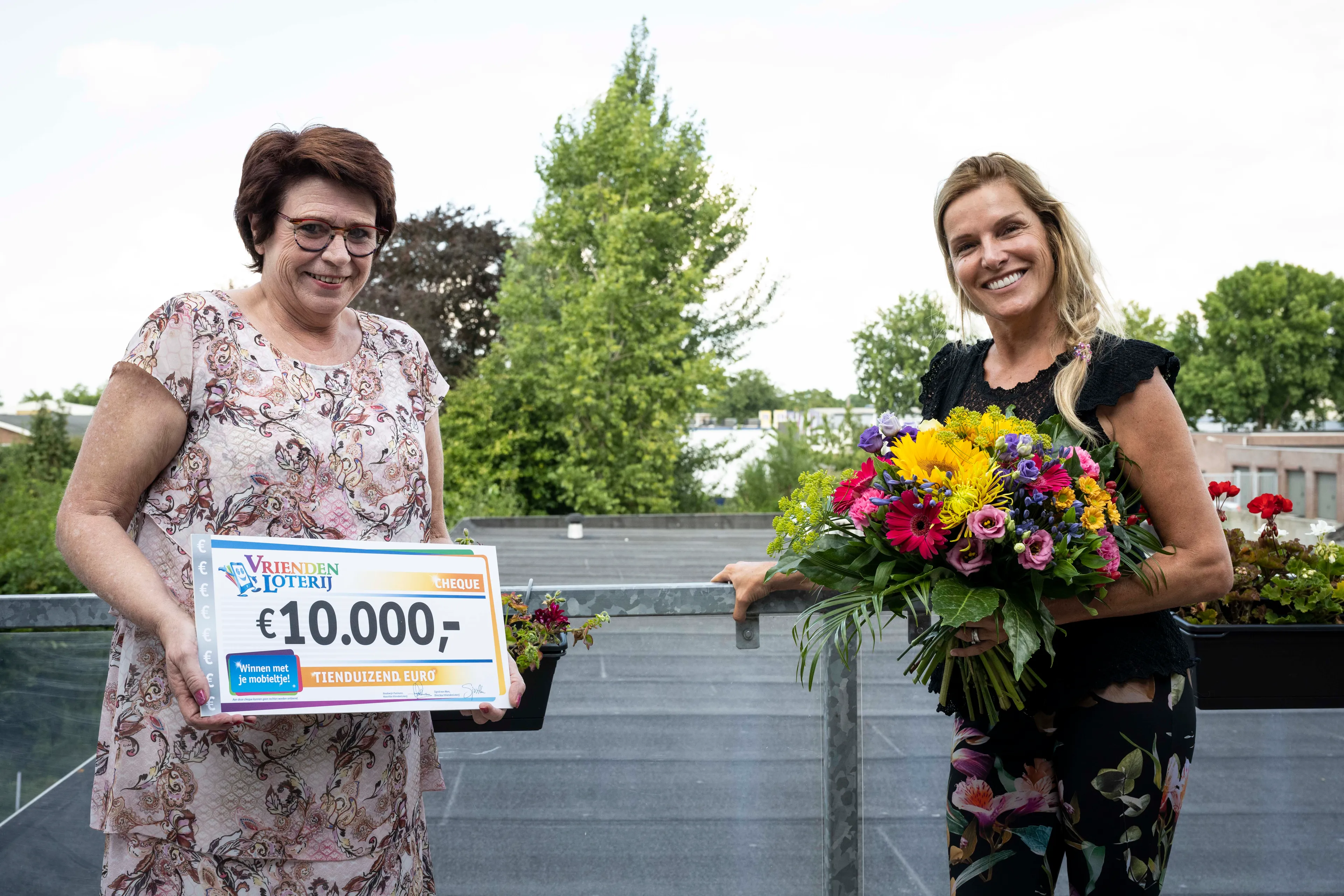 petra neemt cheque van 10000 euro in ontvangst van vriendenloterij ambassadeur lucille werner