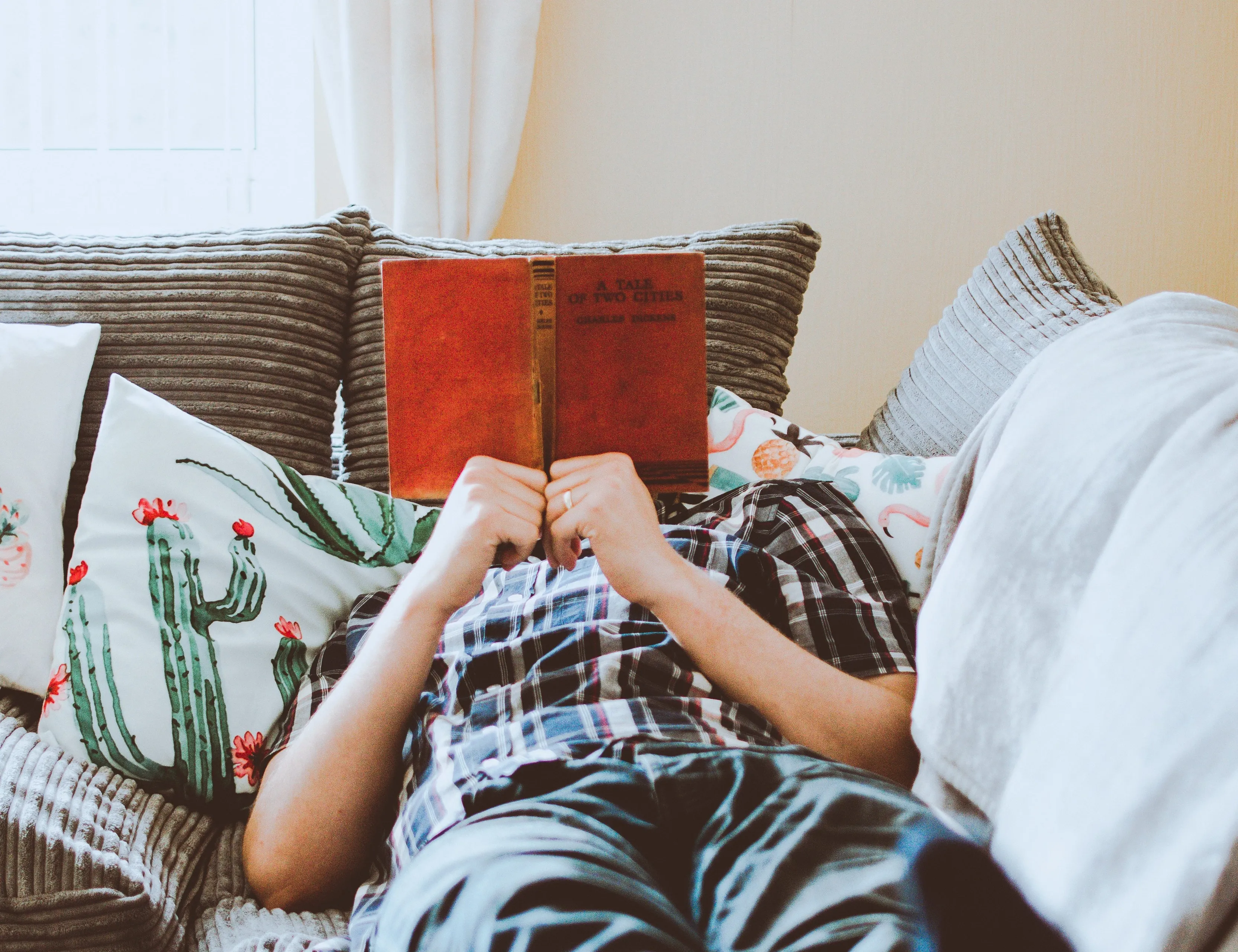 photo of man lying on bed while reading book 1485115 e1585217537930