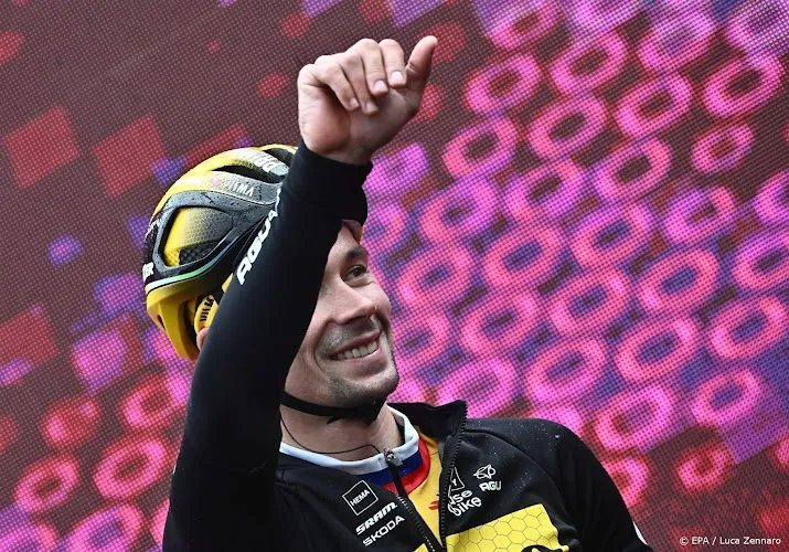 kopman roglic op de fiets van helper bouwman veilig aan de finish