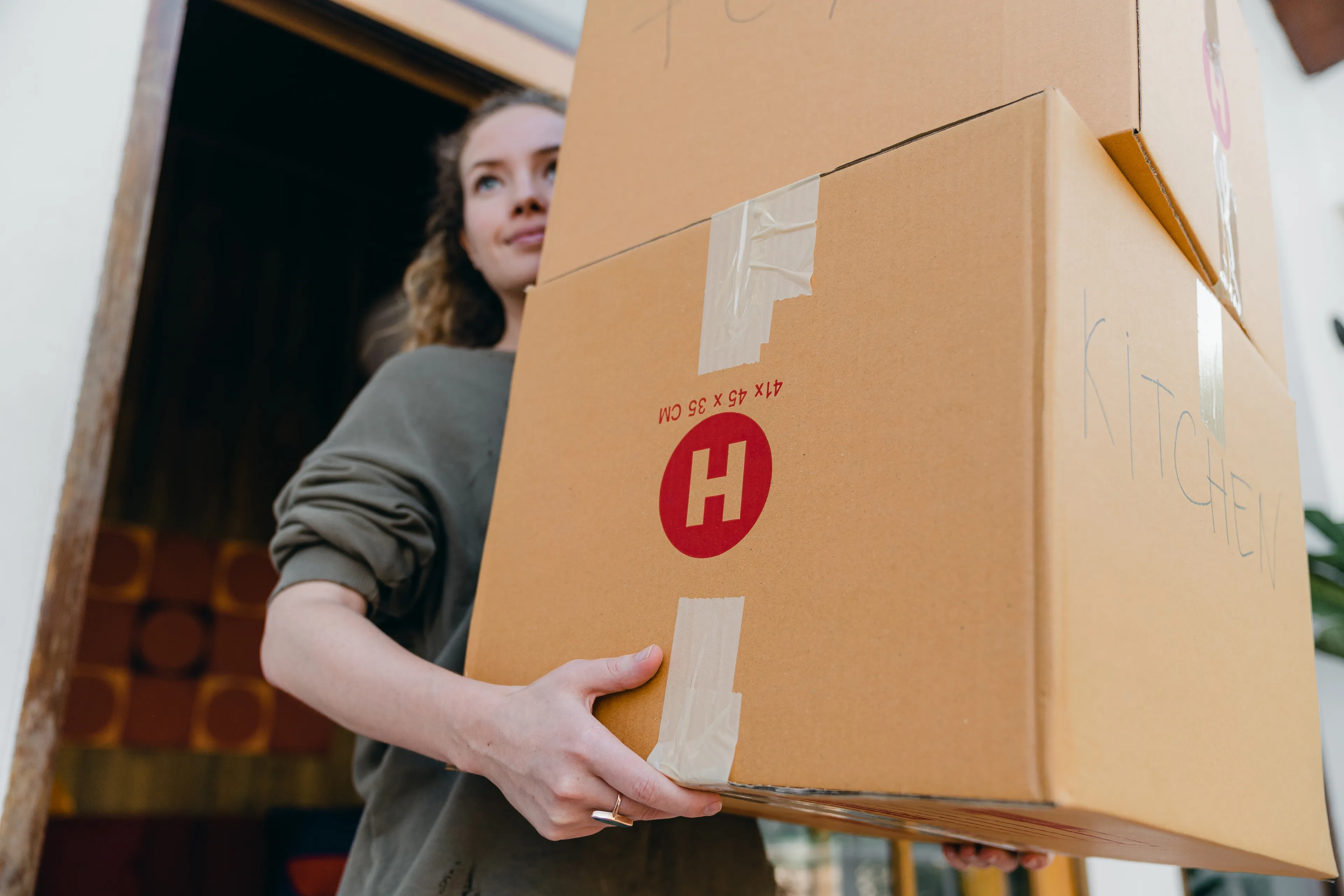 womancarryingboxes pexels
