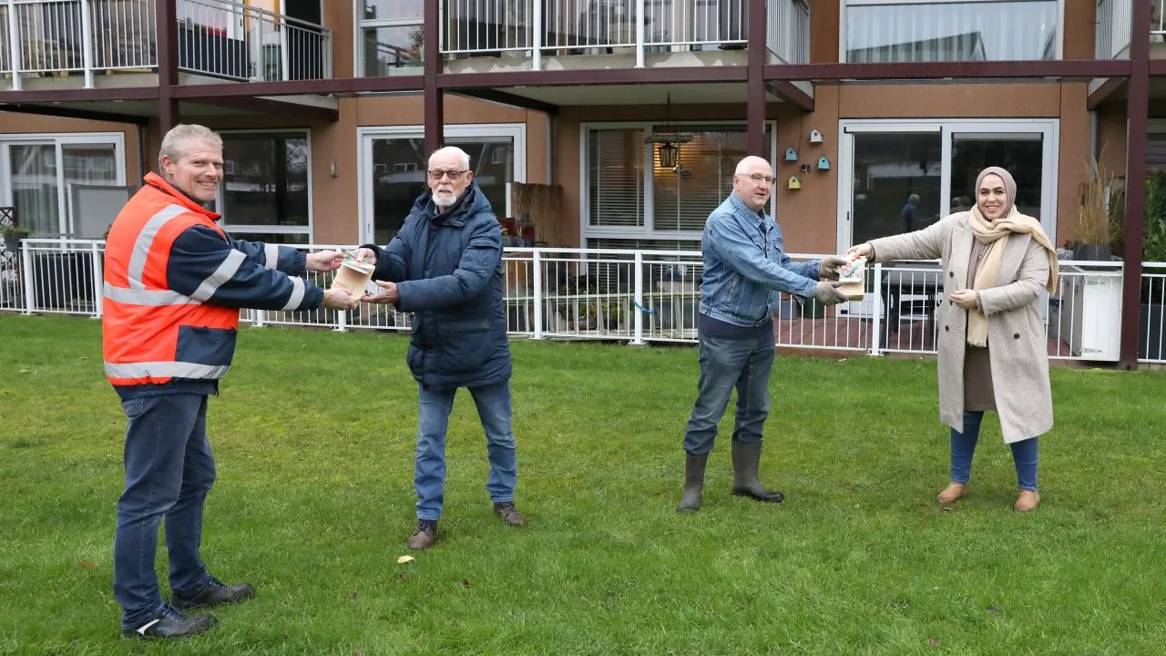 2020 12 04 wethouder nadya aboyaakoub akkouh deelt zakjes met bloembollen uit aan de heer van rennes en de heer klappe gemeente nijkerk
