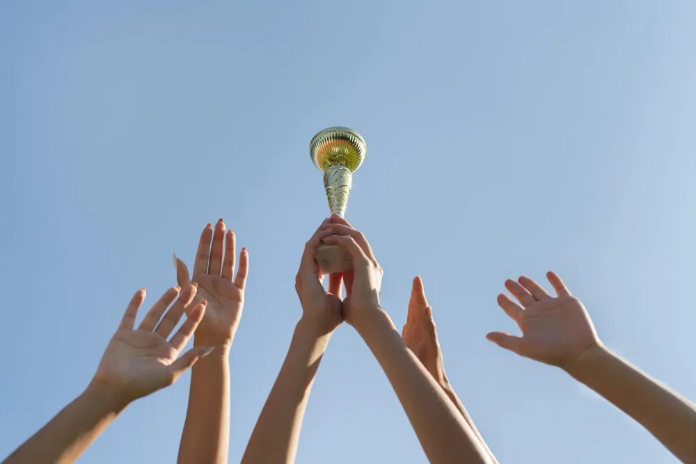 young women holding sports cup