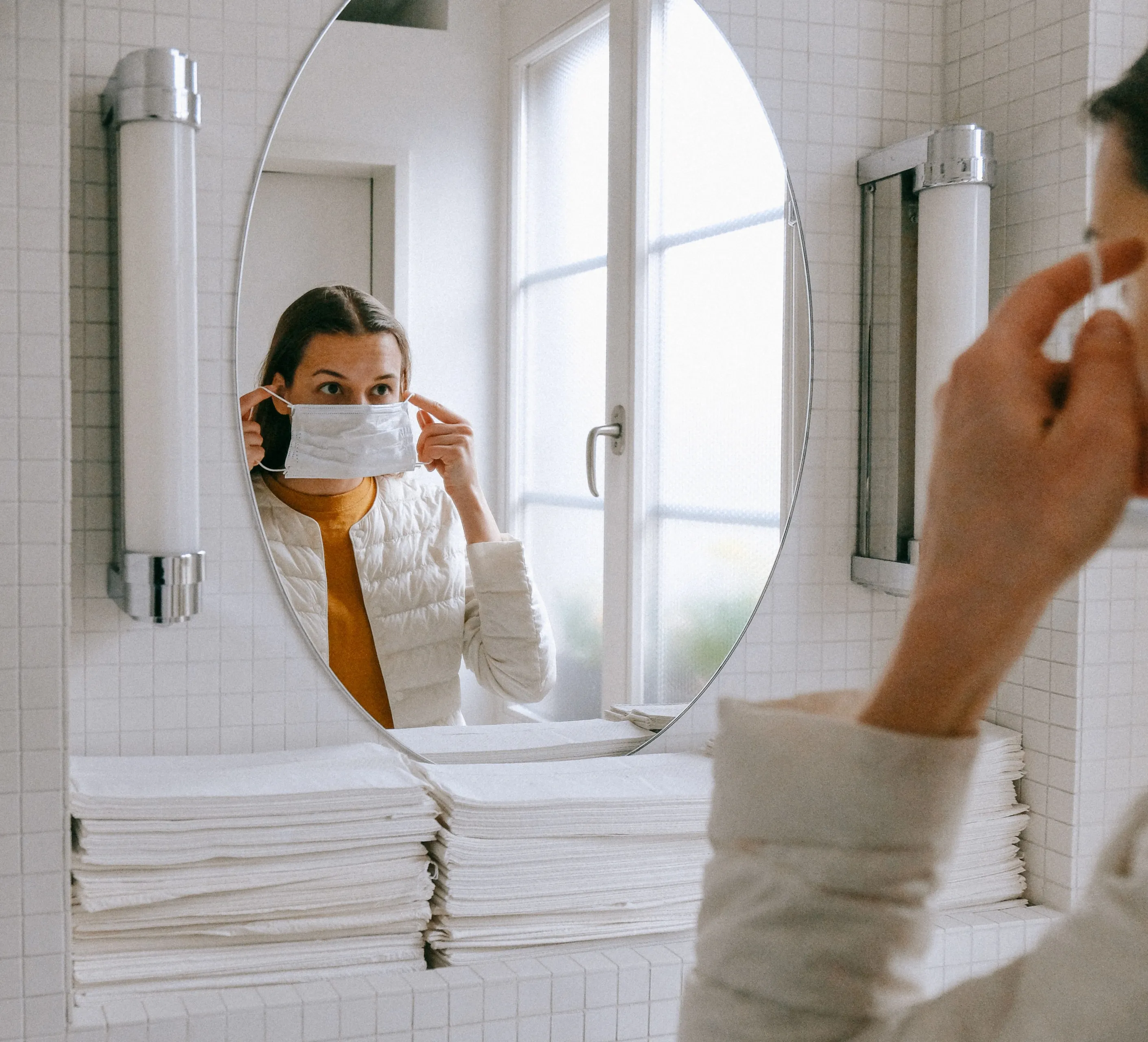 person putting on face mask 3943904 e1585217904387