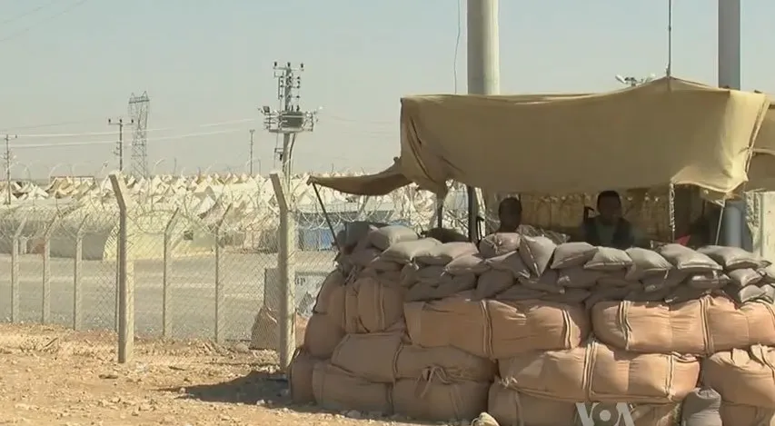 syrian refugee center with soldiers protecting
