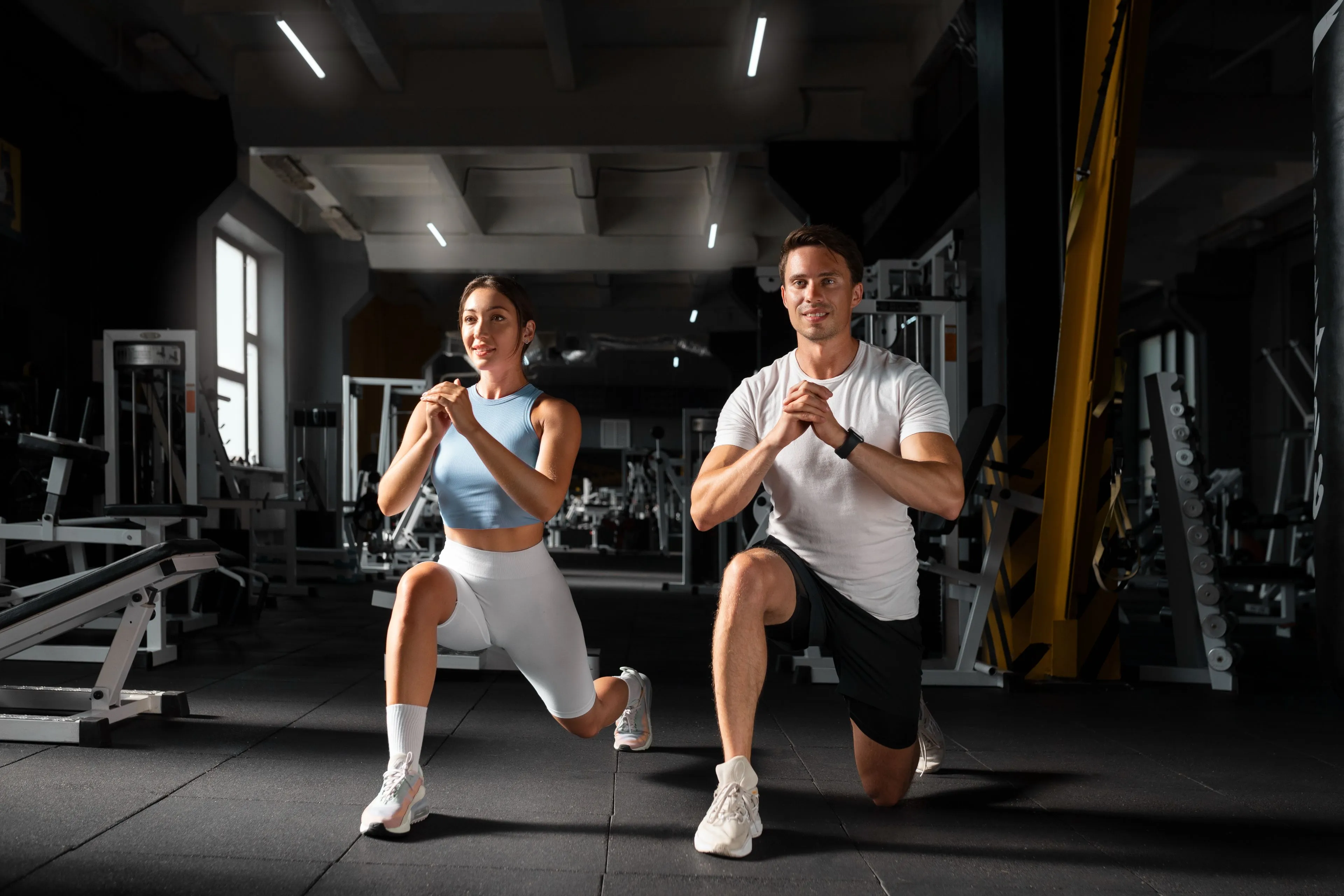 woman helping man gym