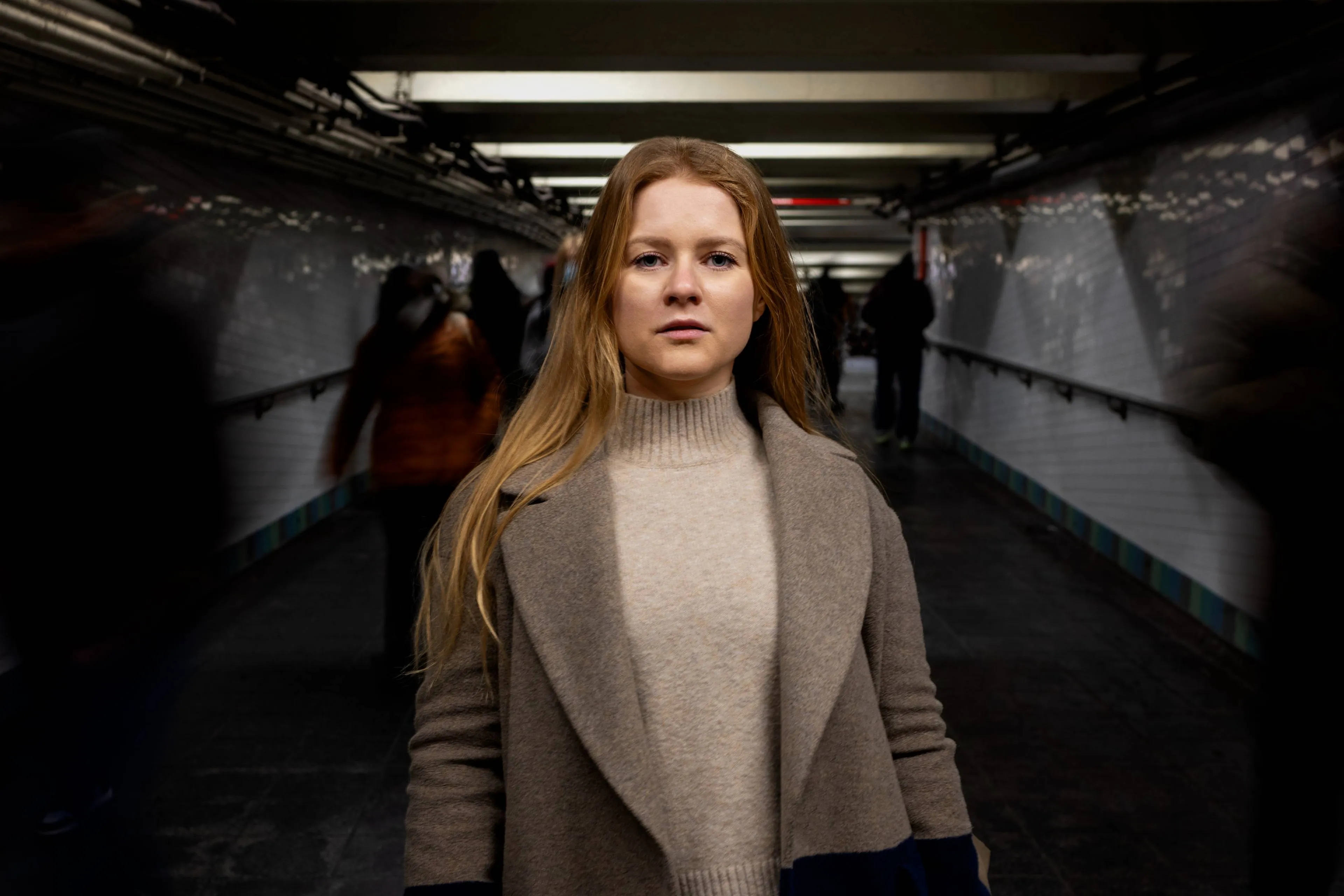 woman-posing-while-traveling-city-subway