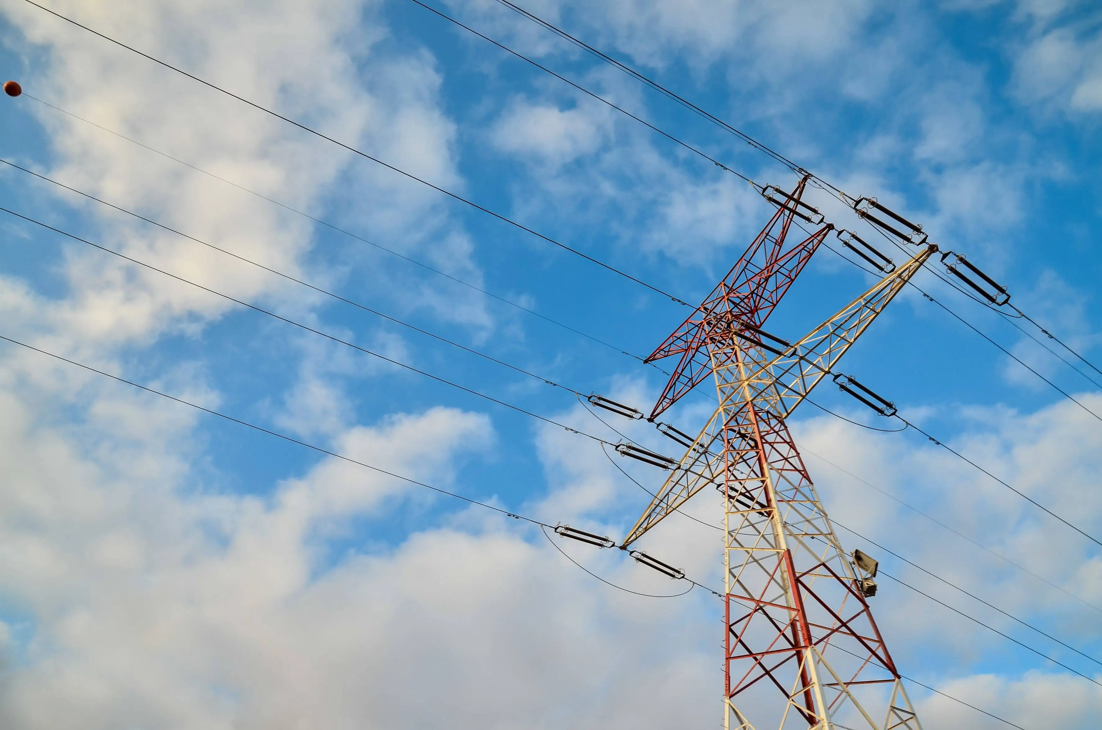 low-angle-shot-high-transmission-tower-with-cloudy-blue-sky