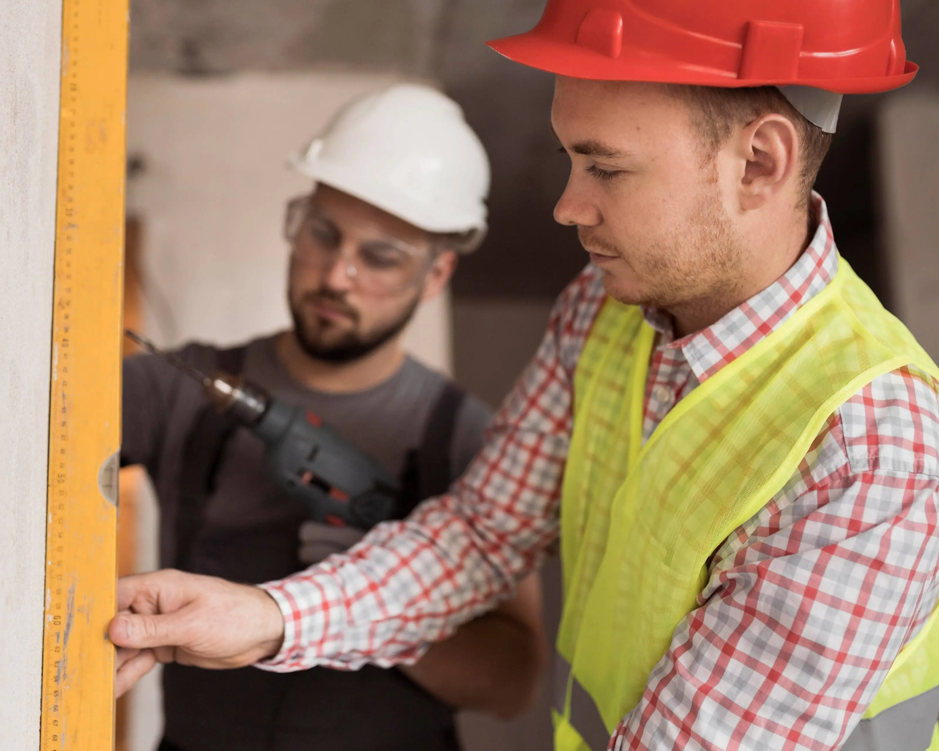 close-up-men-working-together-with-drill