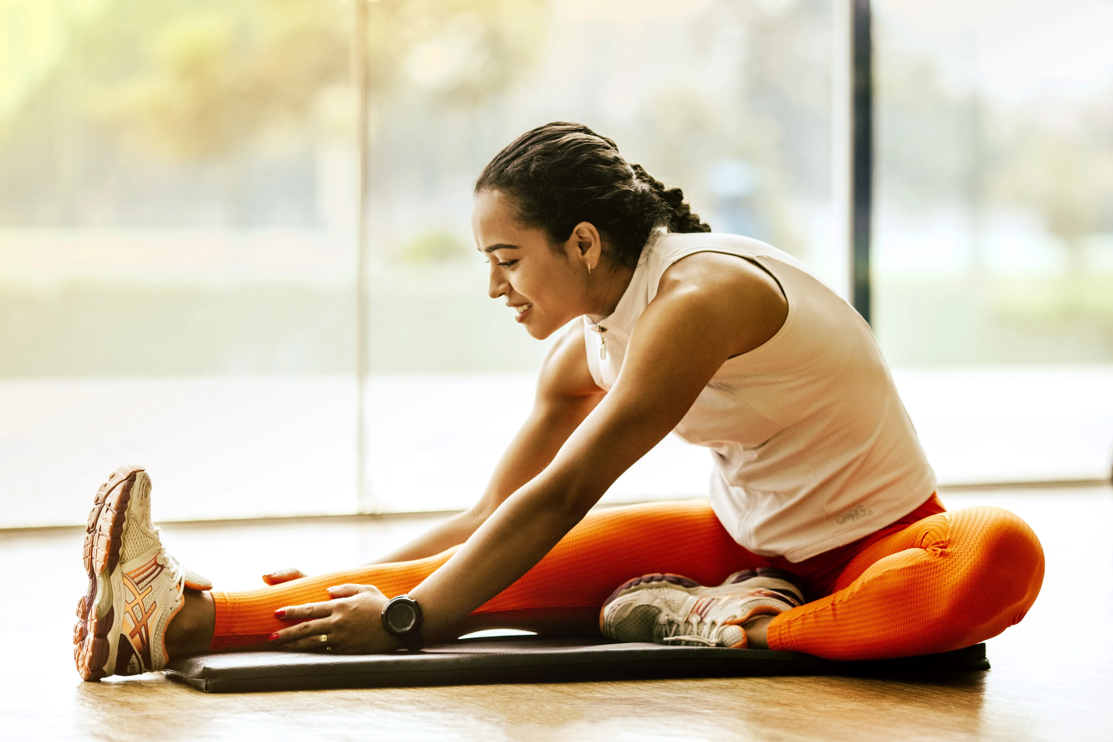 woman stretching on ground 3076509